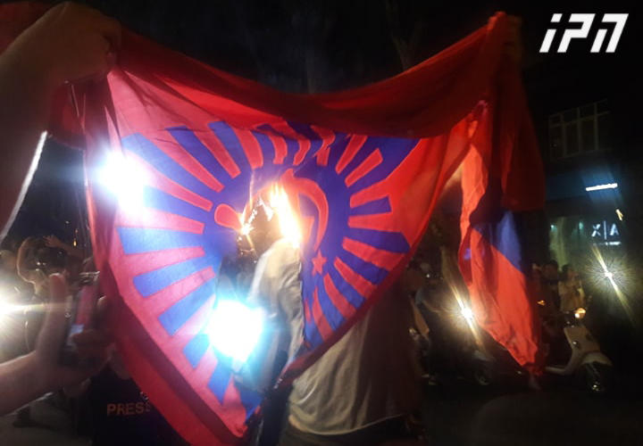 Demonstrators burn Soviet flag