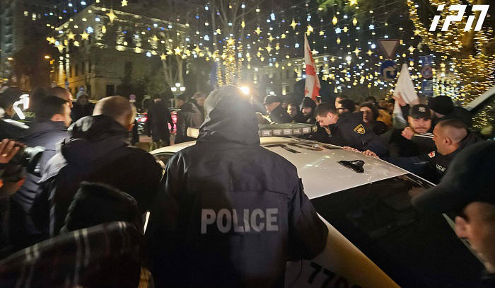 Police detain one of the protest participants near Kashveti